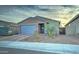 Single-story home with a two-car garage and landscaped front yard at 19945 W Badgett Ln, Litchfield Park, AZ 85340