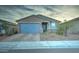 Single story home with blue garage door and landscaping at 19945 W Badgett Ln, Litchfield Park, AZ 85340
