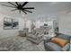 Spacious living room with ceiling fan and neutral color scheme at 19945 W Badgett Ln, Litchfield Park, AZ 85340