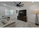 Living room with comfy seating, large TV, and ceiling fan at 19945 W Badgett Ln, Litchfield Park, AZ 85340