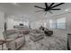 Living room with ceiling fan and comfortable seating at 19945 W Badgett Ln, Litchfield Park, AZ 85340