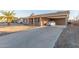 Exterior view of house, driveway, and covered parking area at 2009 W Greenbriar Dr, Phoenix, AZ 85023