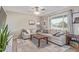 Bright living room featuring a sectional sofa, coffee table, and ceiling fan at 2009 W Greenbriar Dr, Phoenix, AZ 85023