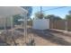 Small backyard with gravel, storage shed, and partial view of a fence at 201 S Greenfield Rd # 16, Mesa, AZ 85206