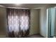 Bright bedroom featuring window with curtains and access to bathroom at 201 S Greenfield Rd # 16, Mesa, AZ 85206