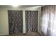 Spacious bedroom with double closets and patterned curtains at 201 S Greenfield Rd # 16, Mesa, AZ 85206