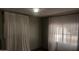 Simple bedroom with light walls and sheer curtains at 201 S Greenfield Rd # 16, Mesa, AZ 85206
