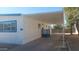 Side view of mobile home showcasing carport and access to the home at 201 S Greenfield Rd # 16, Mesa, AZ 85206