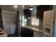 Kitchen with dark cabinets, white appliances, and access to backyard at 201 S Greenfield Rd # 16, Mesa, AZ 85206