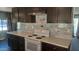 Dark brown cabinetry, white appliances, and patterned backsplash at 201 S Greenfield Rd # 16, Mesa, AZ 85206