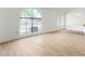 Bright dining room with wood-look floors and a large arched window at 21214 N 124Th Ave, Sun City West, AZ 85375