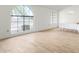 Bright dining room with wood-look floors and a large arched window at 21214 N 124Th Ave, Sun City West, AZ 85375