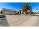 View of the house from the driveway, showcasing the garage and front entrance at 21214 N 124Th Ave, Sun City West, AZ 85375