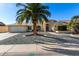 Single story home with desert landscaping and a large driveway at 21214 N 124Th Ave, Sun City West, AZ 85375