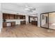 Gathering room with built-in cabinetry, wood flooring and view of kitchen at 21214 N 124Th Ave, Sun City West, AZ 85375