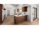 Kitchen with wood cabinets, appliances, and breakfast bar at 21214 N 124Th Ave, Sun City West, AZ 85375
