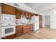 Kitchen features wood cabinets, white appliances, and ample counter space at 21214 N 124Th Ave, Sun City West, AZ 85375