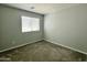 Simple bedroom with a window and carpeted floor at 2180 W Scully Dr, Phoenix, AZ 85023