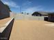 Large backyard space enclosed by concrete block fencing, providing privacy for outdoor activities at 22551 W Pontiac Dr, Surprise, AZ 85387