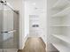Bright bathroom with walk in shower, built in shelves and tiled floors at 22551 W Pontiac Dr, Surprise, AZ 85387