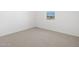 Bedroom with neutral carpet, white walls, and window at 22551 W Pontiac Dr, Surprise, AZ 85387