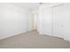 Bedroom featuring neutral carpet, white walls and a closet at 22551 W Pontiac Dr, Surprise, AZ 85387