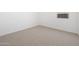 A bright bedroom featuring neutral carpeting and a window for natural light at 22551 W Pontiac Dr, Surprise, AZ 85387