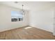 Bright dining area with a modern light fixture and wood-look tile flooring at 22551 W Pontiac Dr, Surprise, AZ 85387