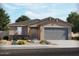One-story home with gray garage doors and stone accents at 22551 W Pontiac Dr, Surprise, AZ 85387