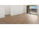 Bright room with a sliding glass door and wood-look tile flooring at 22551 W Pontiac Dr, Surprise, AZ 85387