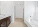 Modern bathroom with double sinks, dark cabinetry, a tub, and a separate shower at 22563 W Pontiac Dr, Surprise, AZ 85387