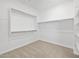Walk-in closet with white shelving and carpet offers ample storage space at 22563 W Pontiac Dr, Surprise, AZ 85387