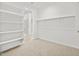 Walk-in closet with white shelving and carpet offers ample storage space and organization at 22563 W Pontiac Dr, Surprise, AZ 85387