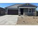 Charming single-story home featuring a two-car garage, stone accents, and low-maintenance landscaping at 22563 W Pontiac Dr, Surprise, AZ 85387