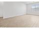 Living room with wood-look flooring, natural light, and recessed lighting at 22563 W Pontiac Dr, Surprise, AZ 85387