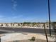 View of the neighborhood park with walking trails, scattered trees, and an open green space at 22563 W Pontiac Dr, Surprise, AZ 85387