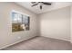 Bright bedroom with large window and ceiling fan at 2527 W Kit Carson Trl, Anthem, AZ 85086