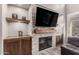 Stunning stone fireplace with built-in shelving and a large TV at 2527 W Kit Carson Trl, Anthem, AZ 85086