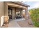 Front porch with two wicker chairs and stone columns at 2527 W Kit Carson Trl, Anthem, AZ 85086
