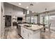 Open kitchen with granite island, stainless steel appliances, and views to living room at 2527 W Kit Carson Trl, Anthem, AZ 85086