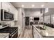 Modern kitchen with granite countertops, stainless steel appliances, and ample cabinet space at 2527 W Kit Carson Trl, Anthem, AZ 85086