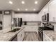 Well-equipped kitchen featuring white cabinets, granite countertops, and modern appliances at 2527 W Kit Carson Trl, Anthem, AZ 85086