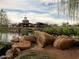 Serene community lake with a gazebo and playground at 2527 W Kit Carson Trl, Anthem, AZ 85086