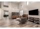 Spacious living room with high ceilings, hardwood floors and a large TV at 2527 W Kit Carson Trl, Anthem, AZ 85086