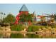 Community playground by a lake with lush landscaping at 2527 W Kit Carson Trl, Anthem, AZ 85086