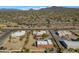 Aerial view showcasing a large property with multiple buildings and mountain views at 2625 W Desert Hills Dr, Phoenix, AZ 85086
