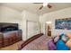 King-size bed, dresser and TV in bedroom with ensuite bathroom at 2625 W Desert Hills Dr, Phoenix, AZ 85086