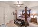 Bedroom with a large four-poster bed and nightstands at 2625 W Desert Hills Dr, Phoenix, AZ 85086