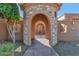 Charming courtyard entry with a stone fountain and brick paved flooring at 2625 W Desert Hills Dr, Phoenix, AZ 85086