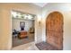 Elegant entryway with arched wood door and view of home office at 2625 W Desert Hills Dr, Phoenix, AZ 85086